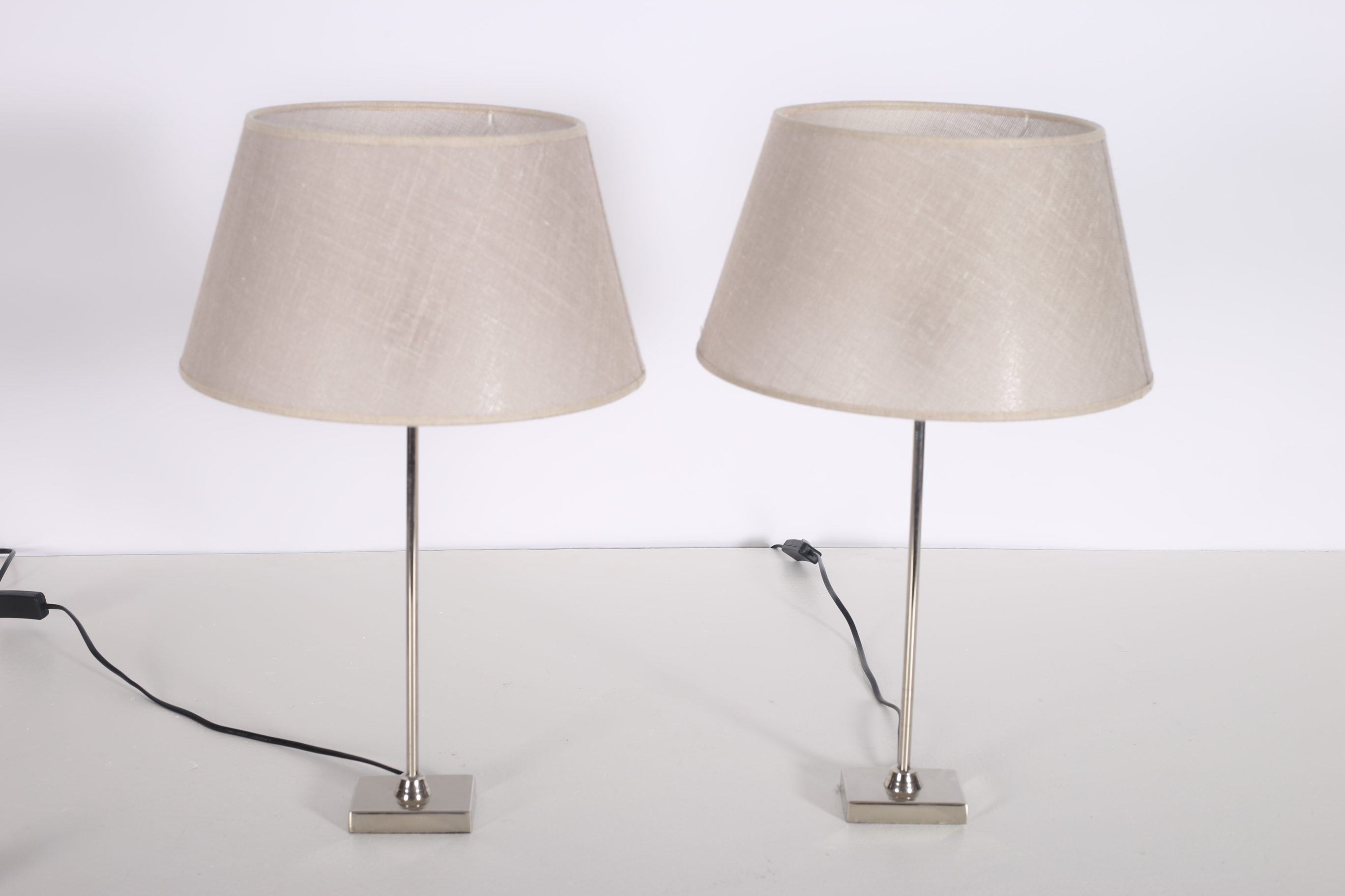 A PAIR OF CONTEMPORARY CHROME TABLE LAMPS each with a cylindrical column on rectangular base with