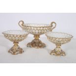 A SUITE OF THREE CONTINENTAL CHINA TAZZAS the white and gilt ground with pierced decoration on a