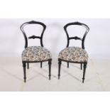 A PAIR OF 19TH CENTURY EBONISED AND PARCEL GILT SIDE CHAIRS each with a curved top rail and splat