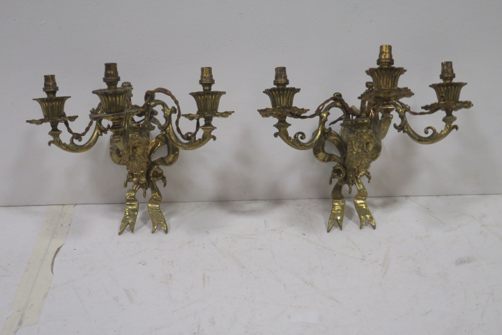 A PAIR OF 19TH CENTURY BRASS THREE BRANCH WALL LIGHTS each with ribbon tied back plate and figural