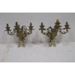 A PAIR OF 19TH CENTURY BRASS THREE BRANCH WALL LIGHTS each with ribbon tied back plate and figural