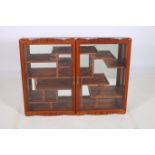 A CHINESE HARDWOOD WALL MOUNTED CABINET of rectangular outline the shaped top above a pair of