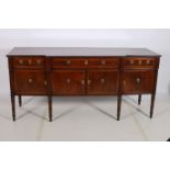 A GEORGIAN MAHOGANY AND SATINWOOD INLAID SIDEBOARD of breakfront outline the shaped top with reeded