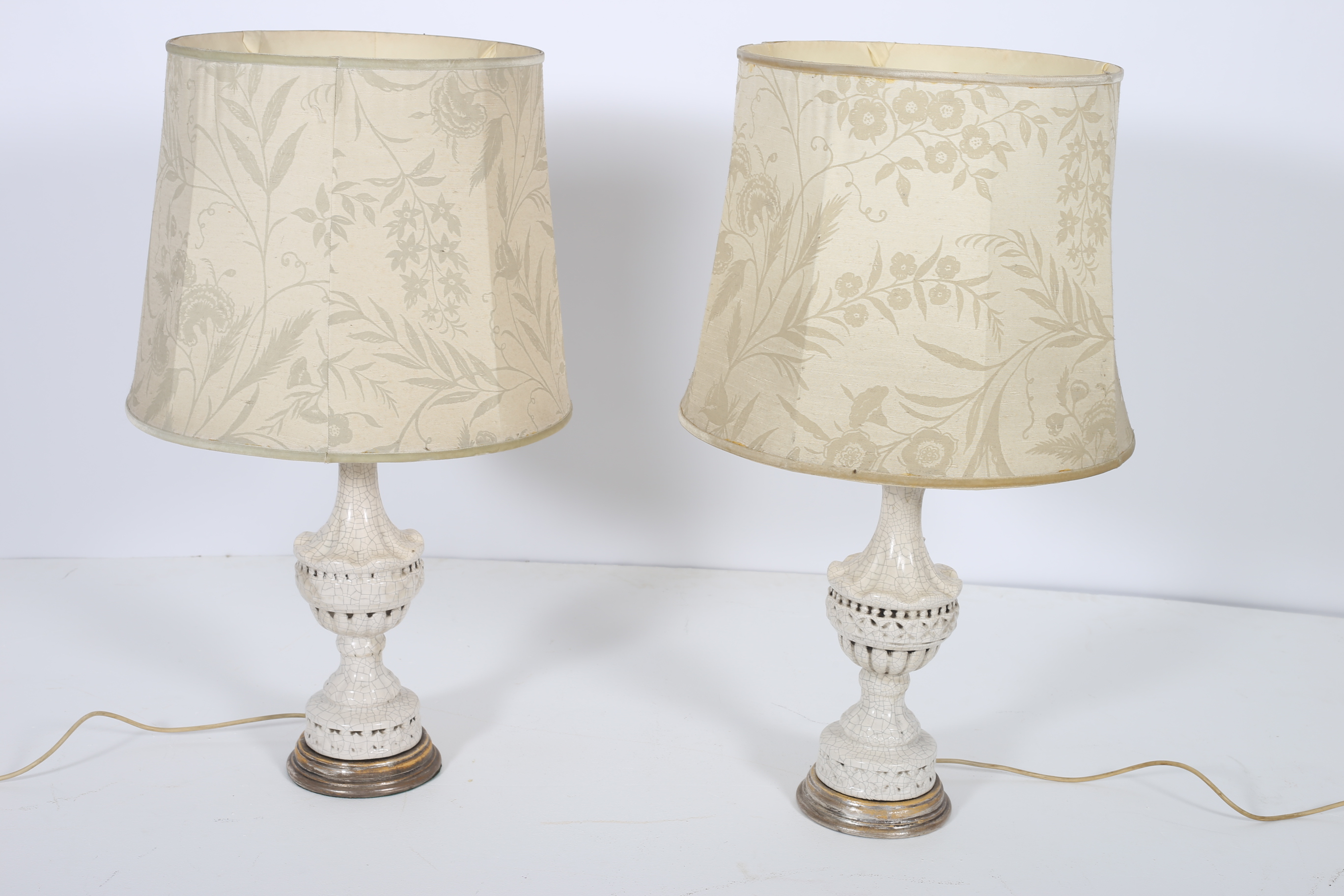 A PAIR OF CONTINENTAL PORCELAIN TABLE LAMPS each of baluster form with silvered base and shades