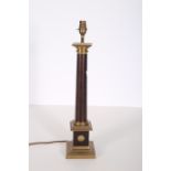 A BRASS AND SIMULATED MAHOGANY TABLE LAMP the cylindrical column above a square stepped base 59cm