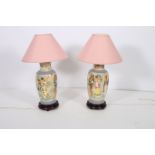 A PAIR OF ORIENTAL TABLE LAMPS the beige and light blue ground decorated with figures in a