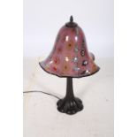 AN ART DECO DESIGN TABLE LAMP the multicoloured mushroom shaped shade above a reeded column on