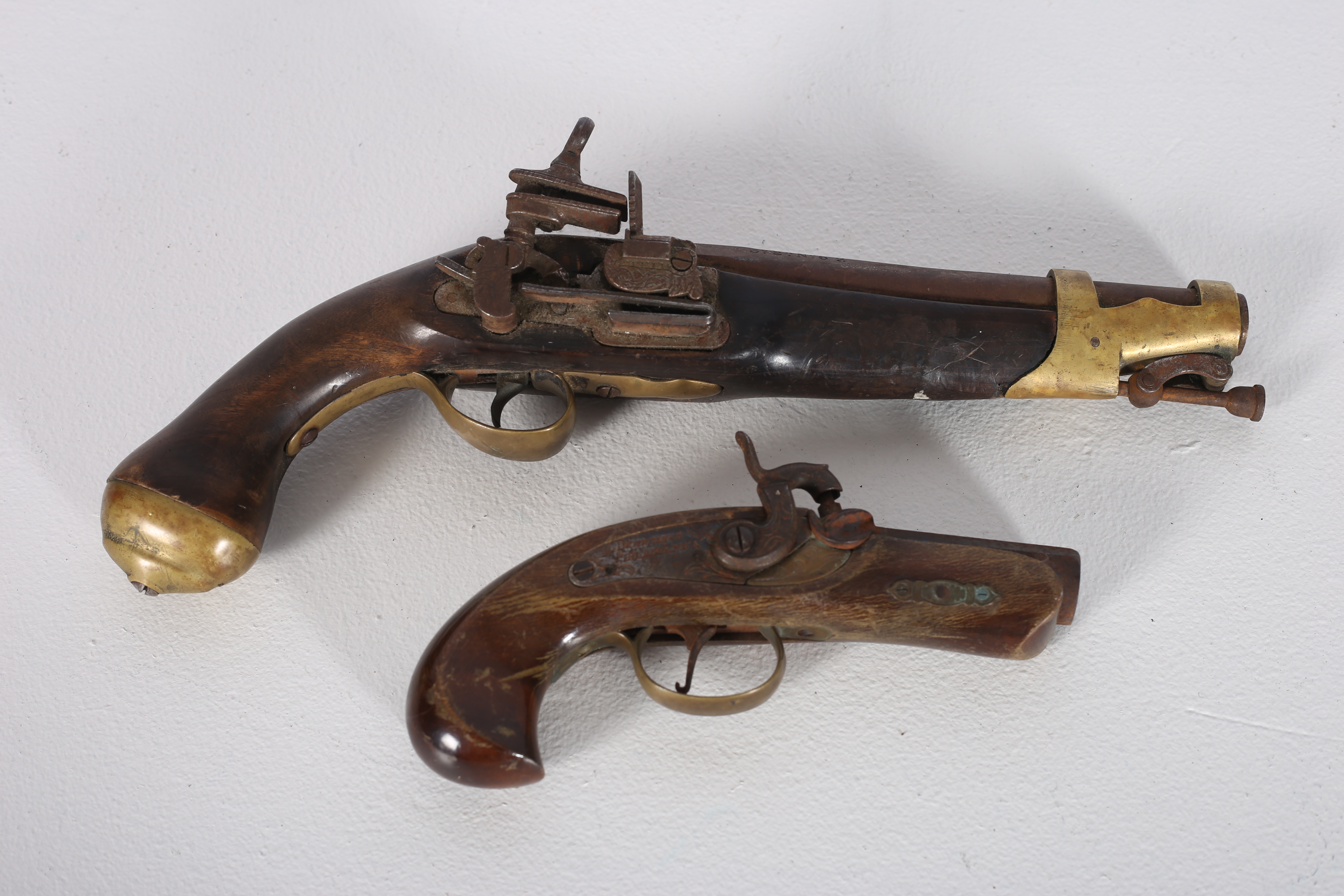 A NAVAL TYPE FLINTLOCK PISTOL with brass fittings together with an American style percussion pocket