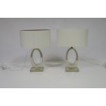 A PAIR OF CLEAR GLASS TABLE LAMPS each with an oval pierced column on a rectangular base with oval