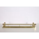 A 19TH CENTURY BRASS FENDER the cylindrical top rail with ball finials on stepped platform base