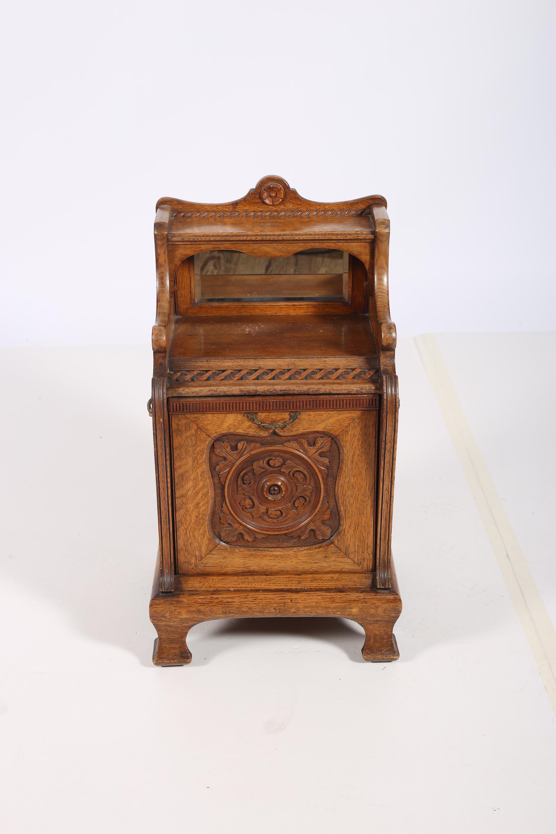 A 19TH CENTURY CARVED OAK FUEL BIN the superstructure with moulded shelf above an open and hinged