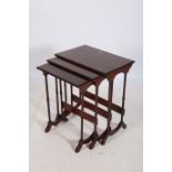 A NEST OF THREE MAHOGANY INLAID TABLES each of rectangular form raised on dual ring turned supports