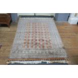 A FINE SIGNED PAJARO WOOL RUG the beige and rust ground filled with serrated panels within a