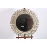 A CONTINENTAL GILT FRAMED MIRROR the circular bevelled glass plate within an intertwined rustic