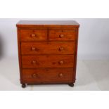 A 19TH CENTURY MAHOGANY CHEST of rectangular outline with two short and three long drawers on bun