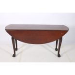 A GOOD GEORGIAN MAHOGANY DROP LEAF TABLE the oval hinged top on cabriole legs with claw and ball
