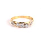 A 9CT GOLD AND DIAMOND THREE STONE DRESS RING .