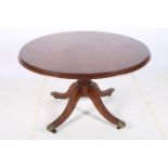 A GEORGE lV MAHOGANY BREAKFAST TABLE of circular outline the reeded rim above a baluster column on
