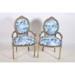 A PAIR OF CONTINENTAL BEECHWOOD AND UPHOLSTERED SALON CHAIRS each with a foliate carved cresting