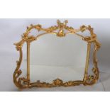 A CONTINENTAL GILT FRAMED MIRROR the rectangular shaped plate within a foliate flowerhead and