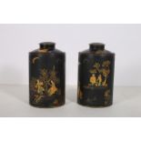 A PAIR OF JAPANNED LIDDED JARS each of cylindrical form decorated with figures flowerheads foliage