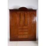 A 19TH CENTURY MAHOGANY AND SATINWOOD INLAID COMBINATION WARDROBE the rectangular arched pediment