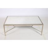 A CONTINENTAL SILVERED METAL COFFEE TABLE of rectangular outline with mottled mirrored inset on