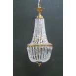 A CONTINENTAL GILT BRASS AND CUT GLASS THREE LIGHT CENTRE LIGHT hung with faceted chains and