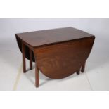 A VERY FINE GEORGIAN MAHOGANY DROP LEAF TABLE the oval hinged top above a moulded apron on square