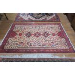 A PERSIAN HANDMADE WOOL RUG the beige ground with central panel filled with stylized animals