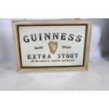 A GUINNESS ADVERTISEMENT MIRROR inscribed Guinness Extra Stout St James's Gate Dublin in moulded