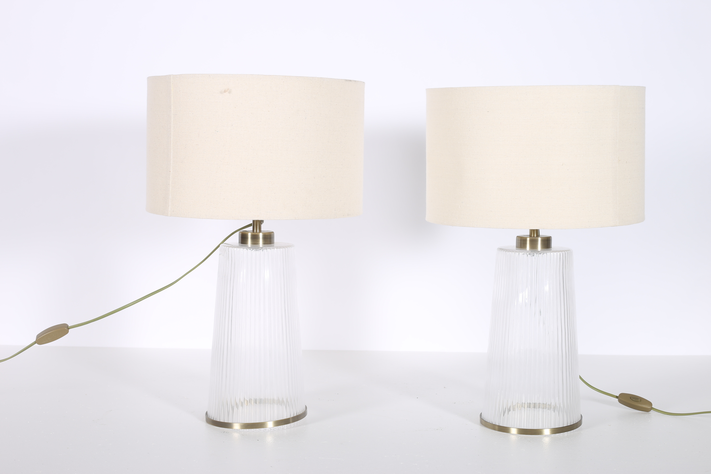 A PAIR OF GLAZED AND GILT METAL TABLE LAMPS each of cylindrical spreading form with shades 56cm (h)
