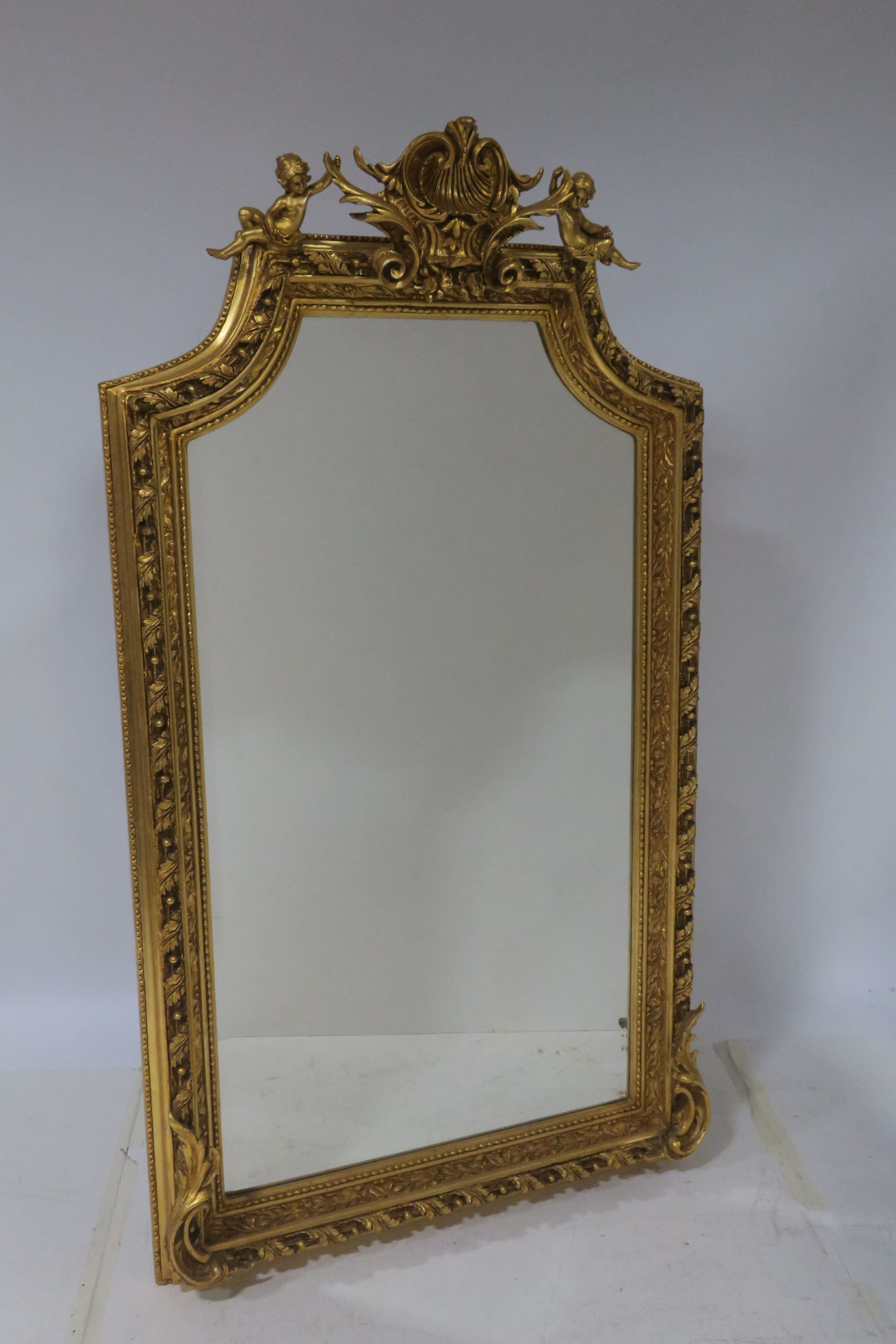 A CONTINENTAL GILTWOOD AND GESSO MIRROR the rectangular shaped bevelled glass plate within a