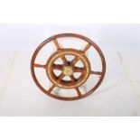A HARDWOOD AND BRASS FRAMED MIRROR in the form of a ship's wheel 60cm (d)