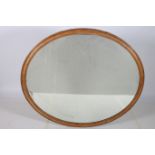 A LARGE 19TH CENTURY PINE FRAMED MIRROR the oval plate within a moulded frame 126cm x 147cm