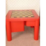 Games table of ebony, holly, leather and red burnished lacquer on birch. Board is reversible for