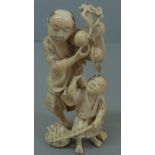 Well carved Japanese ivory Meiji period okimono of a man holding a branch of peaches above a boy,