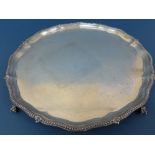 Victorian silver waiter with beaded serpentine border on four ball and claw feet. Diameter 360 mm,