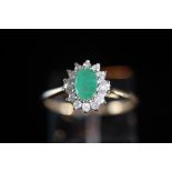 9ct. gold oval emerald and diamond cluster ring - size P