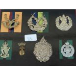 Thirty-six WWI / WWII British Army cap badges mounted on boards