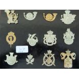 Thirty-five 20thC European Armies cap badges mounted on boards