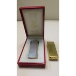 Cartier silver metal gas lighter no. 68351V in original box, together with a Dunhill gold plated gas
