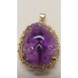 Chinese oval amethyst quartz pendant in the form of a bat hanging onto a peach with 18ct gold