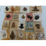 Twenty WWII British Army regimental cap badges