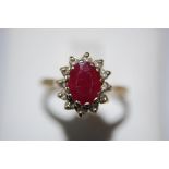9ct. gold oval ruby and white stone cluster ring - size O