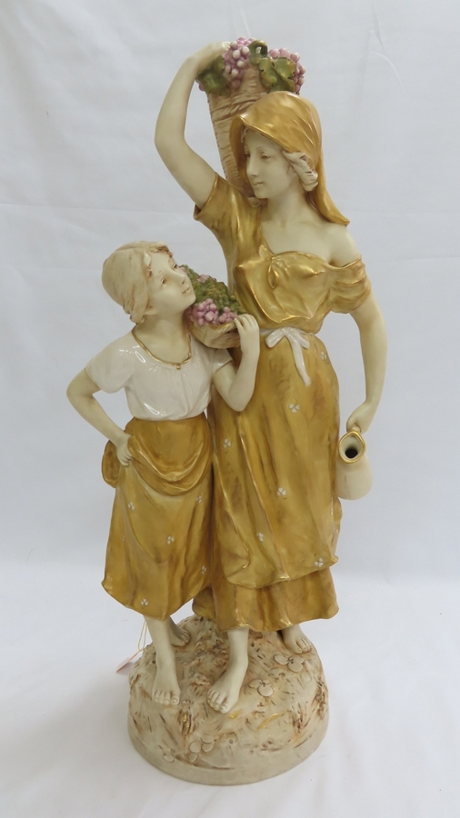 Royal Dux porcelain figure group of woman and girl carrying baskets of grapes. Pink triangular