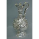Good Victorian chased silver claret jug with decoration of angels, lion mask in relief, acanthus,