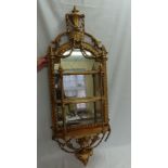 19thC gilt mirrored what-not with three shelves and decoration of urn, swags, vase of flowers,