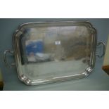 A heavy Victorian silver two handled tray of rectangular form with shaped corners, crested, London