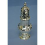 GIII silver sugar caster with turned finial, pierced dome top, belted baluster shaped body on raised